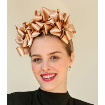 A V V Chapeaux headband covered in a flurry of Barley Dust double sided satin bows, crowning the head from ear to ear.
