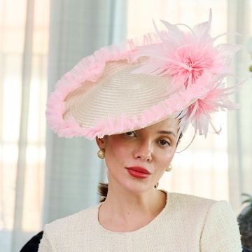 A V V Chapeaux Clotted cream saucer hat detailed with a Pale Peony frilled brim and matching feather flower trim.