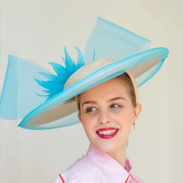 A V V Chapeaux Clotted cream buntal hat with a kingfisher crin brim and a giant crin bow with feather flower centre.